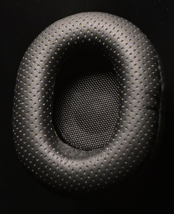 2022 — ETA Mini Semi-Closed — ETA Mini Semi-Closed perforated leatherette earpad close up with metal mesh driver protector