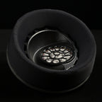 ETA ULI earcup viewed from above, black suede earpad surrounding the 3D-printed driver baffle with floral spoke pattern over the AlNiCo magnet
