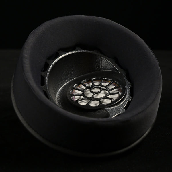 2025 — ETA ULI (Preorder) — AlNiCo Headphone — ETA ULI earcup viewed from above, black suede earpad surrounding the 3D-printed driver baffle with floral spoke pattern over the AlNiCo magnet